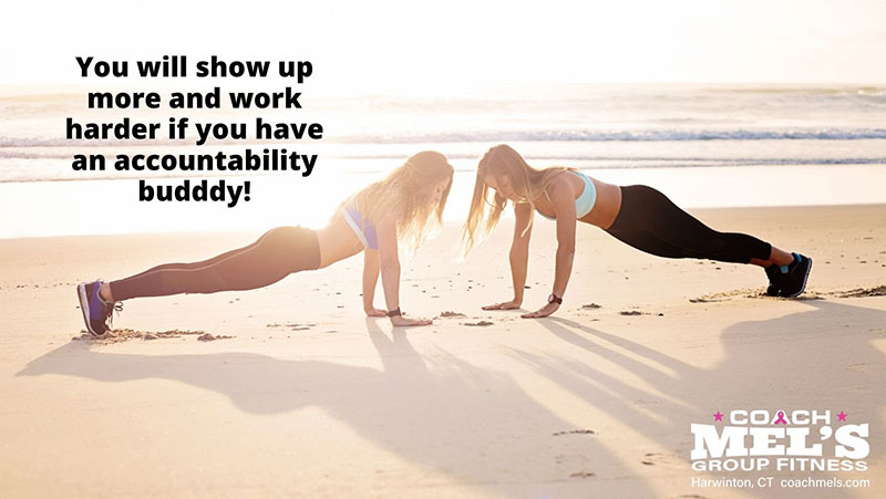 Accountability buddy workout on beach with women doing pushups.