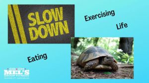 Slow down eating, exercise and life. Turtle and words "slow down" on road.
