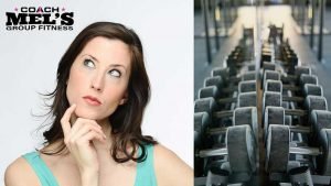 Woman looking puzzled trying to select the proper weights for workout