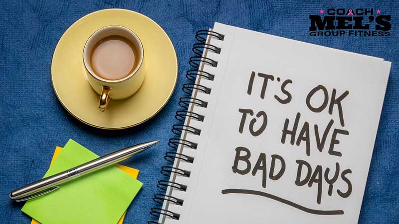 Coffee cup on table with note pad stating, "It's OK to have a bad day".