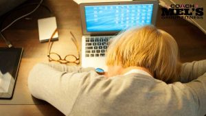 Woman with burnout with head down on laptop